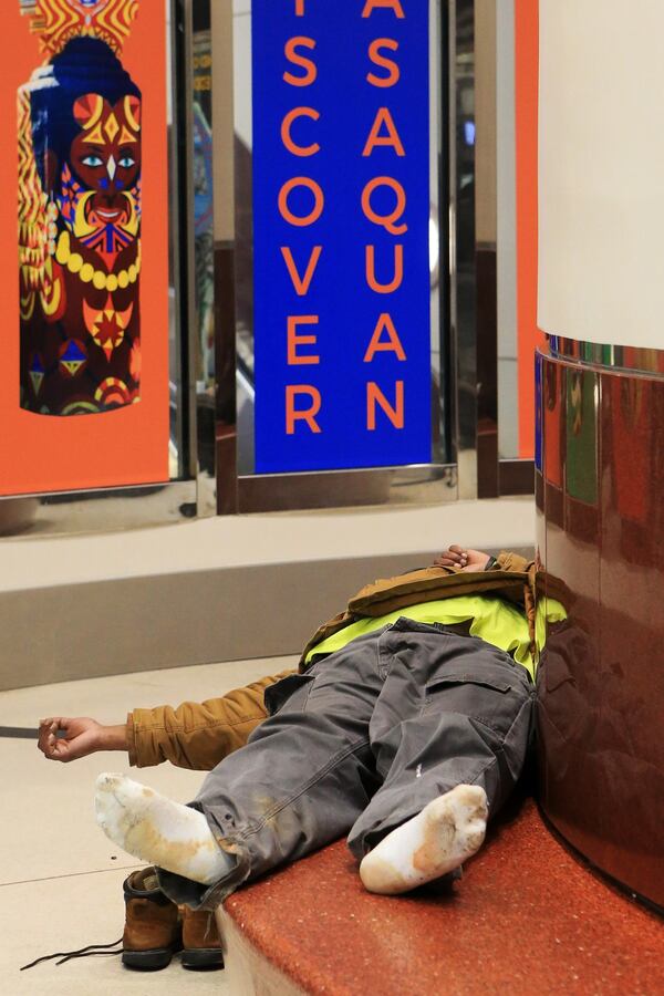 A man sleeps in the domestic terminal of Hartsfield-Jackson International Airport on Friday, February 7, 2020, in Atlanta. Many of Atlanta’s homeless sleep overnight in the airporta’s domestic terminal when the city experiences frigid temperatures. (Christina Matacotta/crmatacotta@gmail.com)