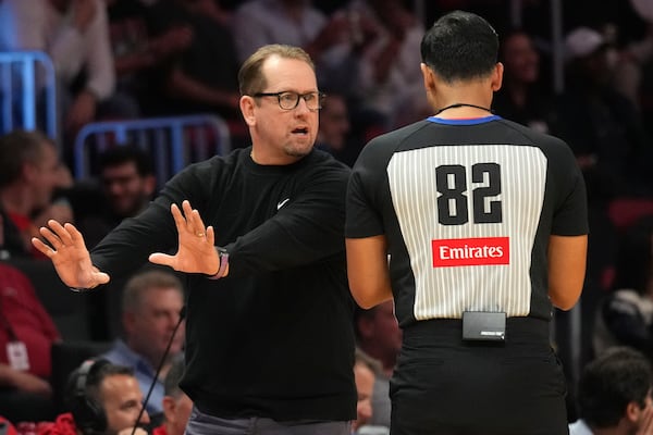 Philadelphia 76ers head coach Nick Nurse, left, talks with official Suyash Mehta (82) during the second half of an NBA basketball game against the Miami Heat, Monday, Nov. 18, 2024, in Miami. (AP Photo/Lynne Sladky)