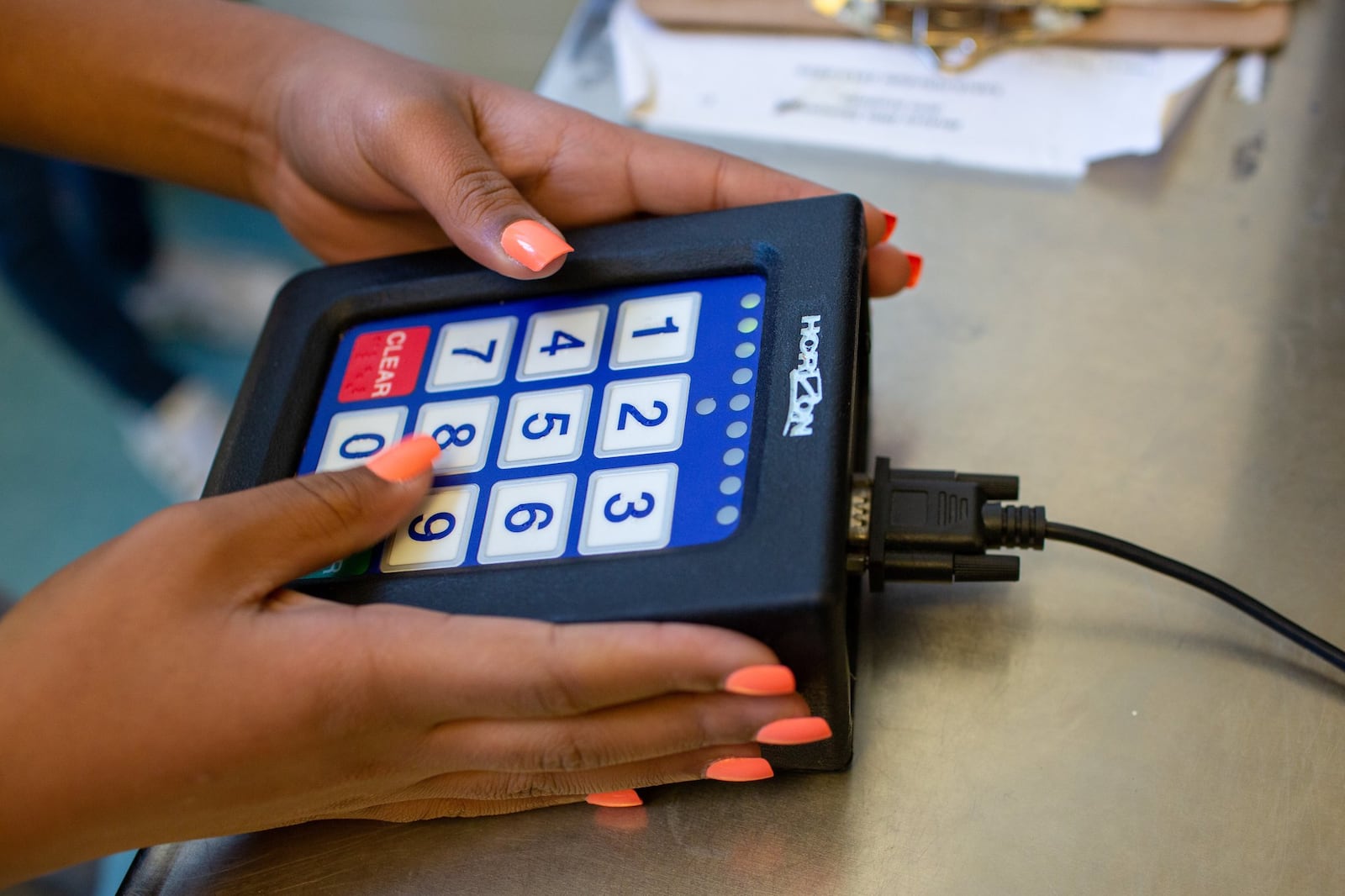 A student punches in their student ID before getting lunch at Hickory Hills Elementary School in Marietta, Georgia, enjoy their lunch on Tuesday, Jan. 21, 2020. Many children in Georgia still cannot afford the standard lunch and either accrue lunch debt or are fed an alternate meal. 