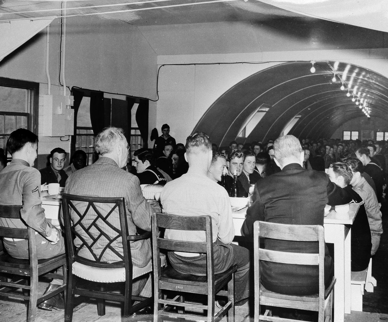 FILE - In this photo provided by the U.S. Navy, President Roosevelt, second from left, has lunch with soldiers, sailors and U.S. Marines as he sits with the two commanding officers in a Quonset hut mess hall at the Naval Air Base at Adak, in the Aleutian Islands, Alaska, Aug. 11, 1944. (AP Photo/U.S. Navy)