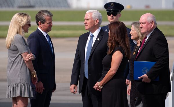 Vice President Mike Pence (center) and his wife, Karen, speak with Gov. Brian Kemp and his wife, Marty after arriving Friday morning, May 29, 2020, at Dobbins Air Reserve Base in Marietta. Standing behind the vice president are U.S. Secretary of Agriculture Sonny Perdue and his wife, Mary. (BEN GRAY for The Atlanta Journal-Constitution)