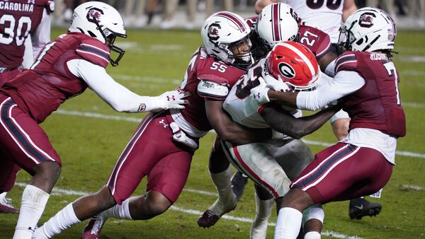 South Carolina's Gilber Edmond (55), Jammie Robinson (7) and Jaylan Foster (27) tackle Georgia running back Daijun Edwards (33) during the second half Saturday, Nov. 28, 2020, in Columbia, S.C. Georgia won 45-16. (Sean Rayford/AP)