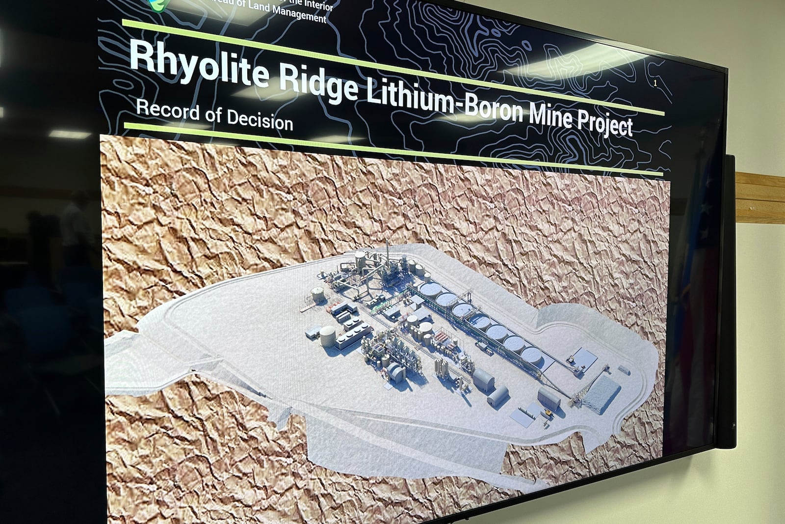 A rendering of a processing facility planned at Ioneer Ltd's lithium mine, scheduled to begin construction next year, is displayed by the U.S. Bureau of Land Management during a news conference in Reno, Nev., Thursday, Oct. 24, 2024, announcing the bureau's approval of a permit for the project. Environmentalists are threatening to sue to try to block the mine they say will drive an endangered wildflower to extinction. (AP Photo/Scott Sonner)