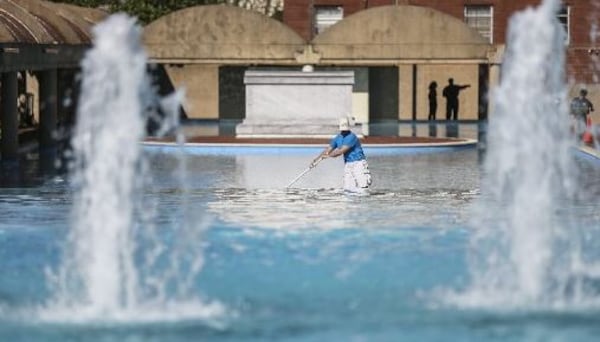 Matt Sutter with American Pools works on the reflecting pool on a clear day at the Martin Luther King Jr. Center for Nonviolent Social Change.  JOHN SPINK / JSPINK@AJC.COM