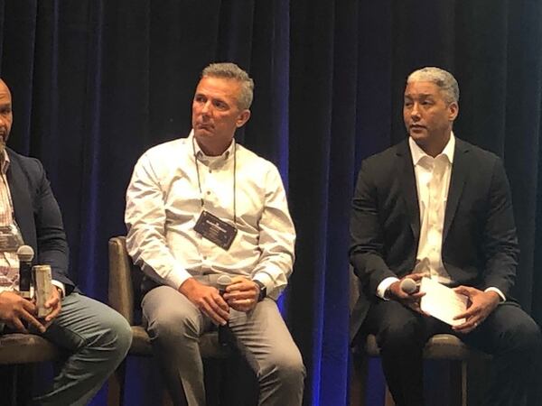 Former Ohio State coach Urban Meyer and moderater Steve Wyche of the NFL Network at the QB Coaching Summit in Atlanta on Monday. (By D. Orlando Ledbetter/dledbetter@ajc.com) 