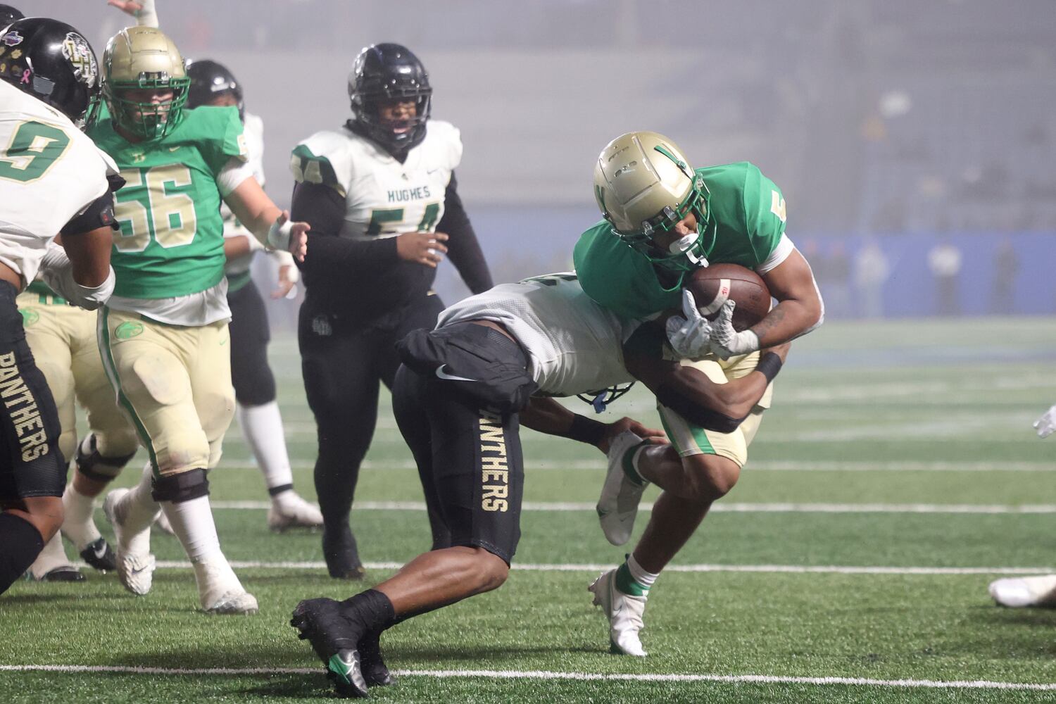 Buford running back CJ Clinkscales (5) scores a touchdown against Langston Hughes defensive back Rodney Shelley (6) during the first half of the Class 6A state title football game at Georgia State Center Parc Stadium Friday, December 10, 2021, Atlanta. JASON GETZ FOR THE ATLANTA JOURNAL-CONSTITUTION