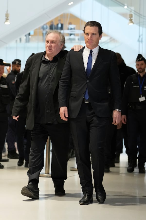 Actor Gerard Depardieu, left, arrives at his trial for the alleged sexual assaults of two women on a film set in 2021, with his lawyer Jeremie Assous ,Tuesday, March 25, 2025 in Paris. (AP Photo/Aurelien Morissard)