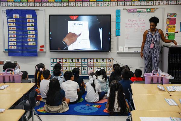 Deianaira Earle, who has been participating in a new intensive training program for teachers focused on the science of reading, works with students in her first grade class at John Lewis Elementary on Friday, Sept. 2, 2022. (Natrice Miller/natrice.miller@ajc.com)