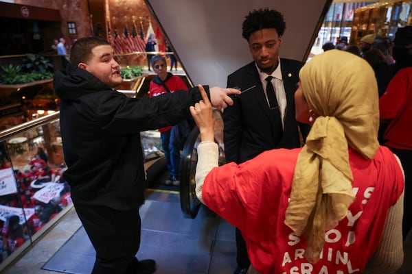 Security personnel with Trump Tower confront a demonstrator from the group, Jewish Voice for Peace, as they protest inside Trump Tower in support of Columbia graduate student Mahmoud Khalil, Thursday, March 13, 2025, in New York. (AP Photo/Yuki Iwamura)