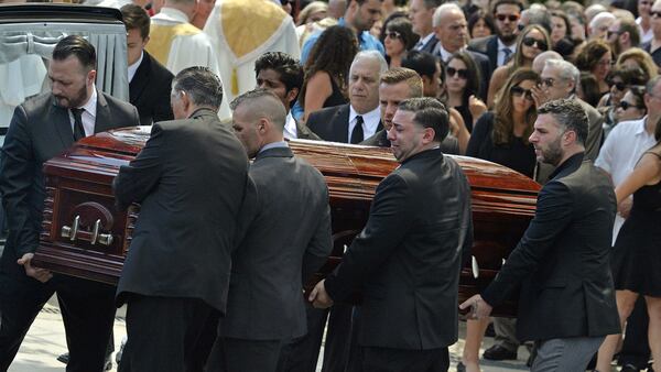 Mourners carry the casket of Karina Vetrano, 30, from St. Helen's Church following her funeral Aug. 6, 2016, in the Howard Beach section of Queens. The trial of Chanel Lewis, a 21-year-old man accused of sexually assaulting, beating and strangling Vetrano, ended in a mistrial late Tuesday, Nov. 20, 2018. Lewis is expected to face a second trial in January 2019.