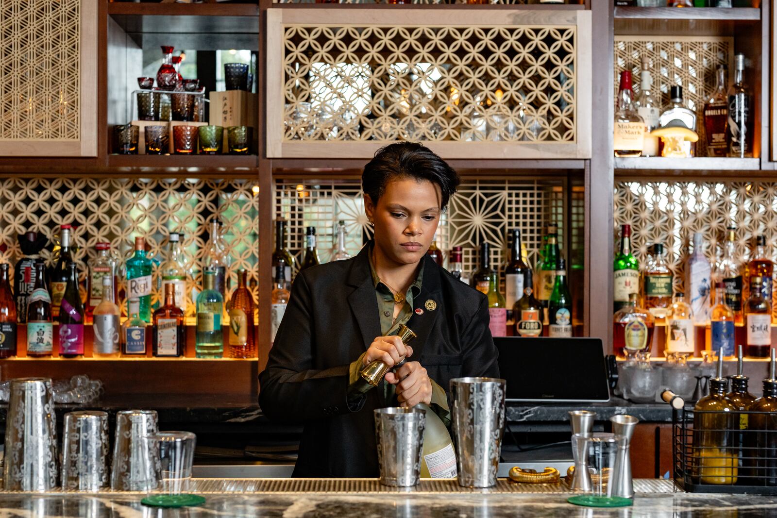 Mona Allen pours some of her favorite sakes at Brush Sushi. Allen is certified by the Sake School of America, an organization endorsed by the Sake Service Institute International, Japan’s largest sake sommelier certification organization. (Jason Allen/Atlanta Journal-Constitution) 