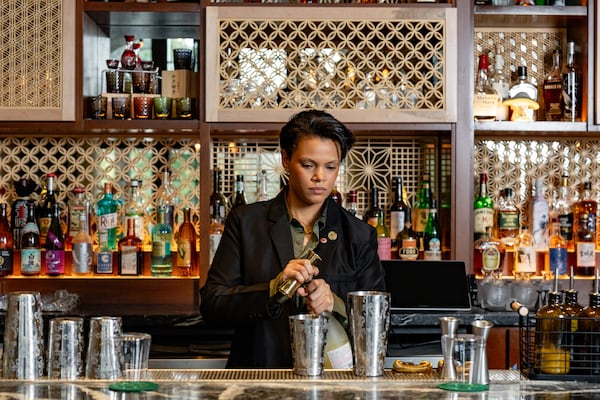 Mona Allen pours some of her favorite sakes at Brush Sushi. Allen is certified by the Sake School of America, an organization endorsed by the Sake Service Institute International, Japan’s largest sake sommelier certification organization. (Jason Allen/Atlanta Journal-Constitution) 