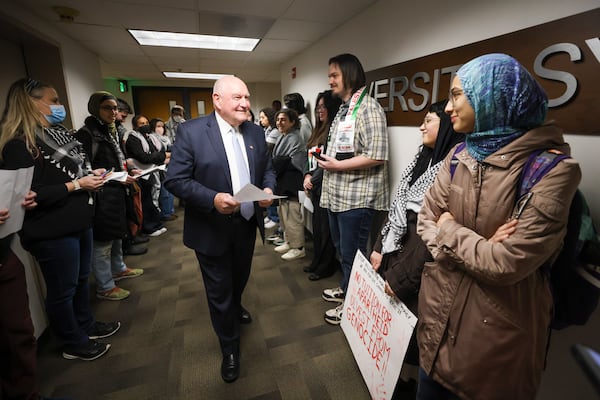 University System of Georgia Chancellor Sonny Perdue talks with a group of students and alumni of various system colleges and universities before the Board of Regents meeting on Tuesday, Jan. 14, 2025, in Atlanta. (Jason Getz/AJC)