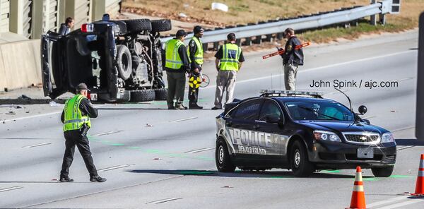 An SUV flipped on its side after a crash involving a DeKalb police cruiser on I-20 West near Candler Road. 