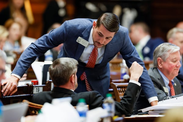 Republican state Rep. Trey Kelley of Cedartown, standing, talks with state Rep. J Collins, R-Villa Rica, in the Georgia House on Wednesday, the final day of the 2023 legislative session. Jason Getz / Jason.Getz@ajc.com)
