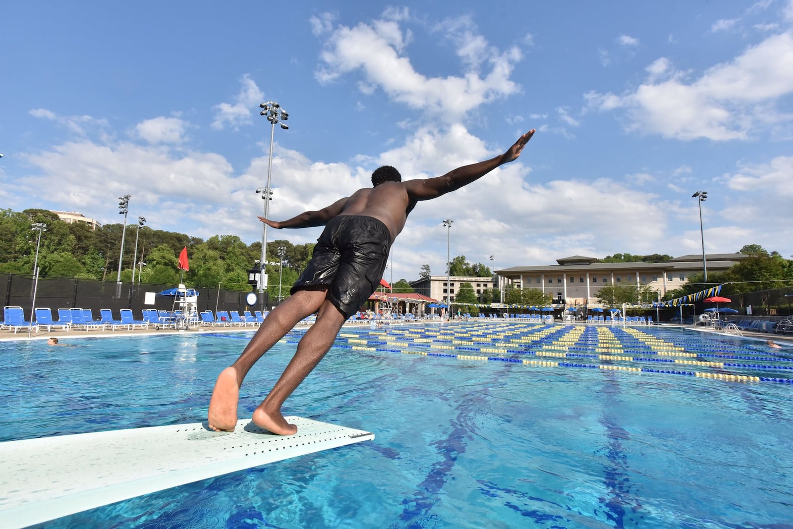 A swimmer jumps off the diving board at the Emory Aquatics Center at the Student Activity and Academic Center HYOSUB SHIN / HSHIN@AJC.COM