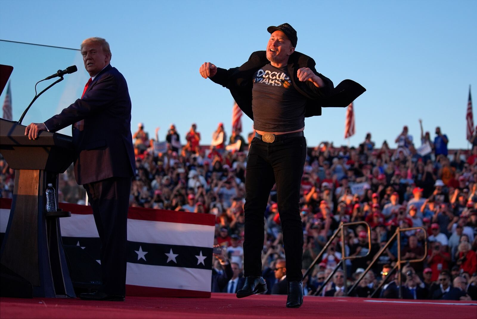 FILE - Elon Musk jumps on the stage as Republican presidential nominee former President Donald Trump speaks at a campaign rally at the Butler Farm Show, Saturday, Oct. 5, 2024, in Butler, Pa. (AP Photo/Evan Vucci, File)