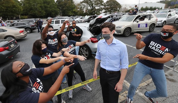 Democratic U.S. Senate candidate Jon Ossoff gets a warm welcome from Biden supporters as he arrives for Presidential candidate Joe Biden's visit to Georgia at a drive-in event at the amphitheatre at Lakewood on Tuesday, Oct. 27, 2020 in Atlanta, Georgia. (Curtis Compton/Atlanta Journal-Constitution/TNS)