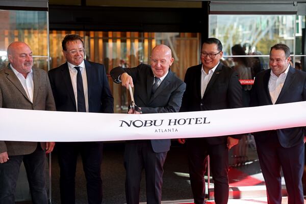 Nobu Hospitality Group CEO Trevor Horwell cuts the ribbon during the ribbon-cutting ceremony of the Nobu Hotel Atlanta at Phipps Plaza in Buckhead, Wednesday, November 30, 2022, in Atlanta, Ga.. Jason Getz / Jason.Getz@ajc.com)