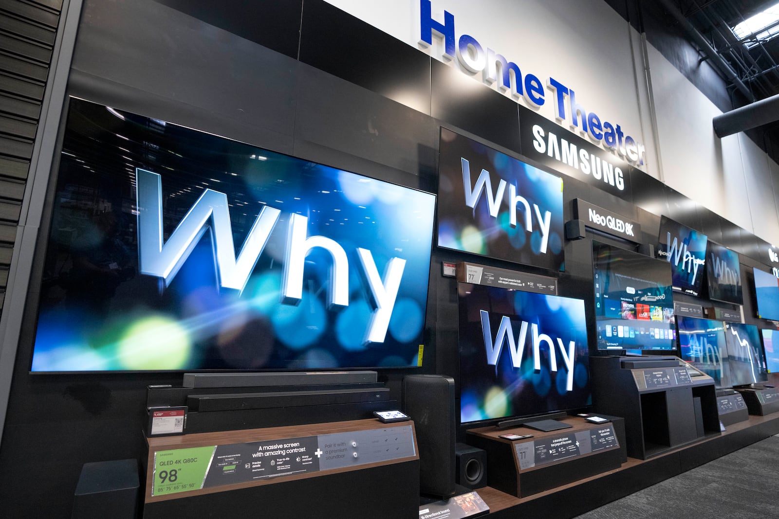 An 98-inch Samsung television, left, sits by others of various sizes on display at a Best Buy store in Dallas, Friday, Oct. 25, 2024. (AP Photo/Tony Gutierrez)