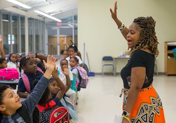 Lajuana Ezzard, Harper-Archer Elementary School Director of Partnerships and Programs, interacts with students in the school's after school program during their meal time in the cafeteria, October 2, 2019. The program hosts many programs that feature science, technology, engineering, arts and math. (ALYSSA POINTER/ALYSSA.POINTER@AJC.COM)