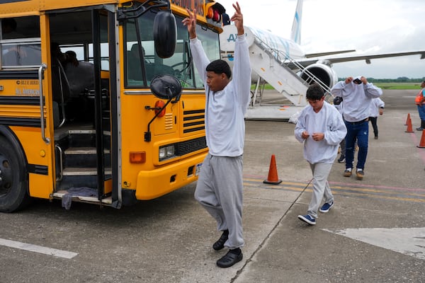 A Honduran migrant celebrates upon arriving at Ramon Villeda Morales Airport in San Pedro Sula, Honduras, after being deported from the U.S., Wednesday, Dec. 4, 2024. (AP Photo/Moises Castillo)