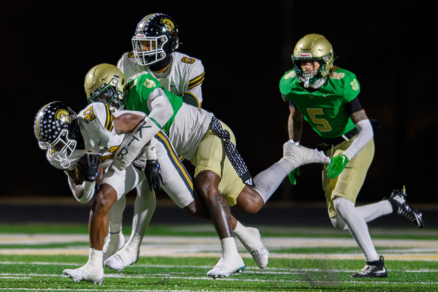 Carrollton’s Kimauri Farmer is tackled by Buford. (Jamie Spaar for the Atlanta Journal Constitution)