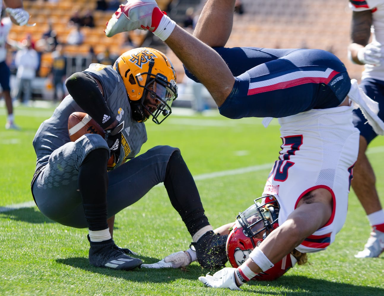 Xavier Shepherd (left), freshman quarterback for Kennesaw State, gets tackled by Brian Davison (right) of Dixie State. CHRISTINA MATACOTTA FOR THE ATLANTA JOURNAL-CONSTITUTION.