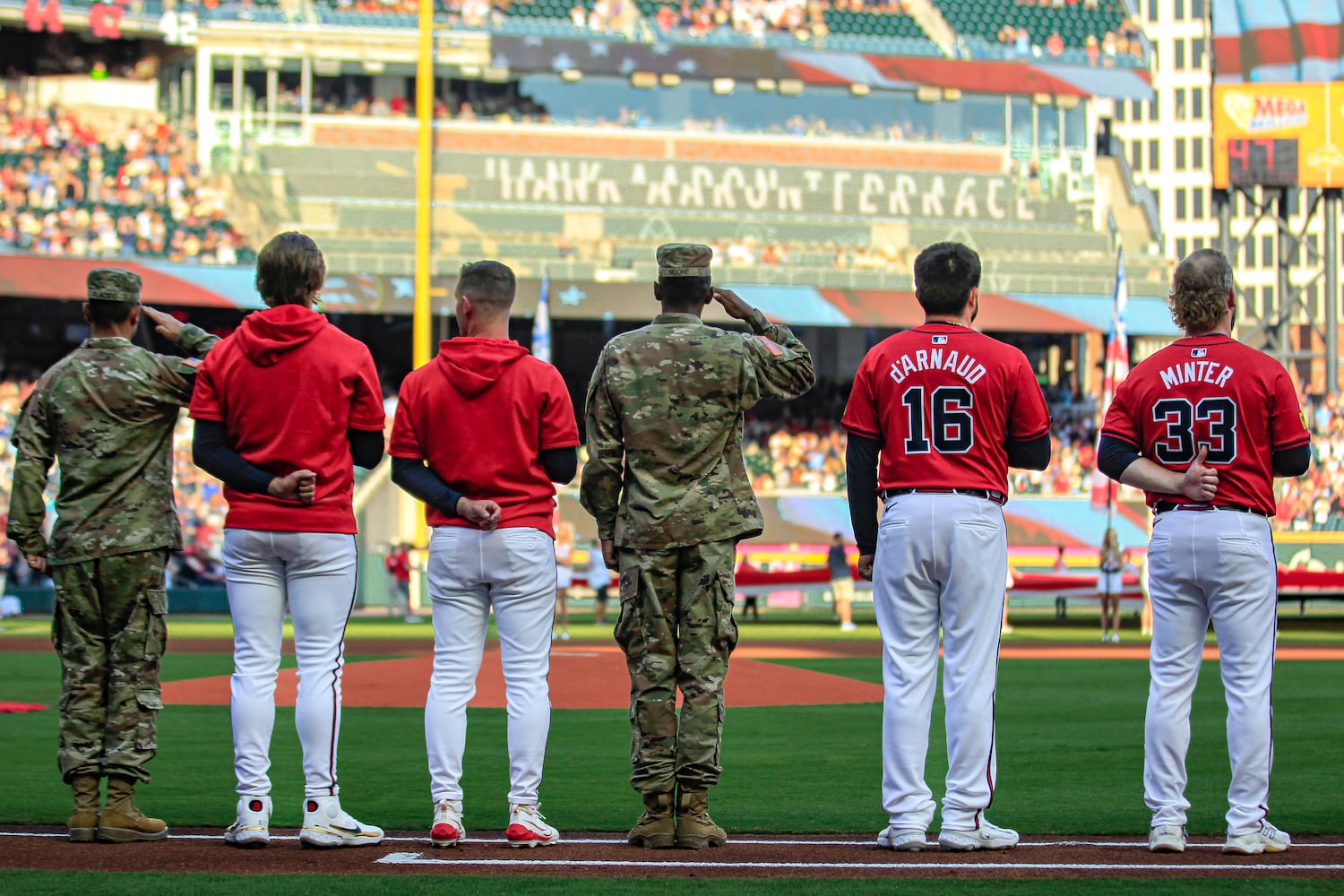 Atlanta Braves players stand together with U.S. Army soldiers during the singing of national anthem to commemorate Flag Day and Army Birthday before the game against the Tampa Bay Rays at Truist Park in Atlanta, Georgia  on Friday, June 14, 2024.   (Ziyu Julian Zhu / AJC)