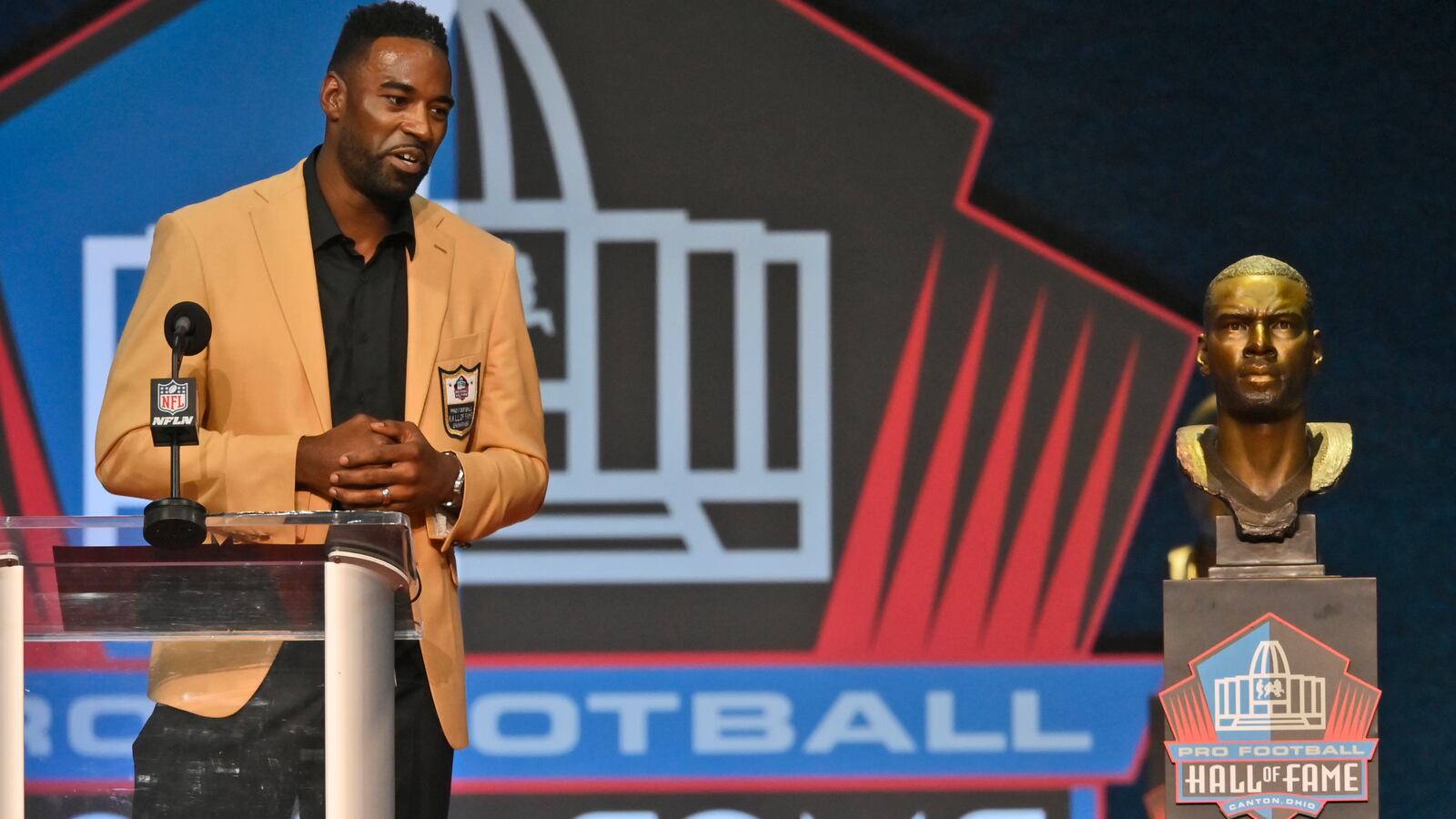 Calvin Johnson, a member of the Pro Football Hall of Fame Class of 2021, speaks during the induction ceremony at the Pro Football Hall of Fame, Sunday, Aug. 8, 2021, in Canton, Ohio. (David Richard/AP)