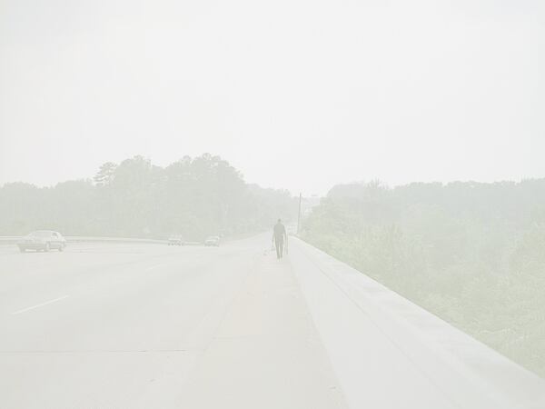 “Man Walking With Blue Bags, Augusta,” by Paul Graham, whose solo show, “The Whiteness of the Whale,” will be at the High Museum of Art through Oct. 22. COPYRIGHT PAUL GRAHAM / CONTRIBUTED BY PACE/MACGILL GALLERY, NEW YORK