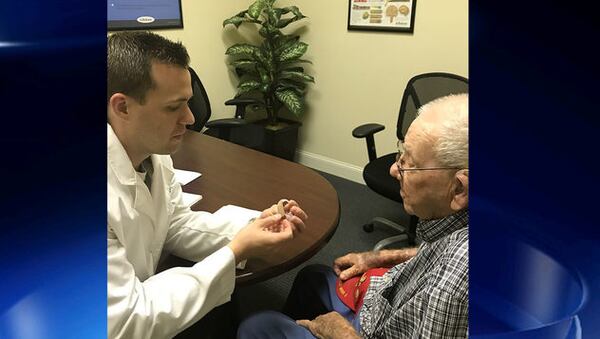 World War II vet Jesse Eugene Slaton, right, is fitted f or new hearing aids, after his daughter wrote a heartfelt letter to the Beltone Hearing Care Foundation.