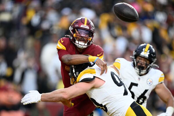 Washington Commanders quarterback Jayden Daniels is pressured by Pittsburgh Steelers linebacker T.J. Watt (90) during the second half of an NFL football game, Sunday, Nov. 10, 2024, in Landover, Md. (AP Photo/Nick Wass)