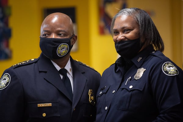 Interim Chief Rodney Bryant (left) congratulates Officer Veronica Campbell.