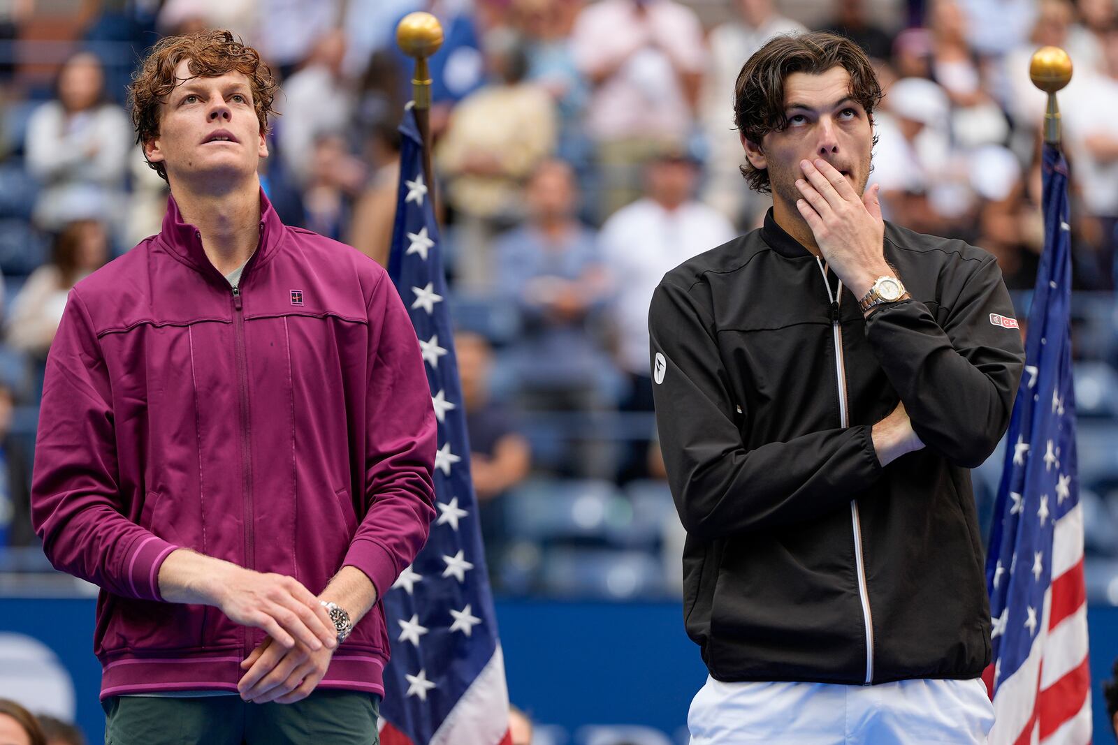 Jannik Sinner, of Italy, and Taylor Fritz, of the United States, listen to comments during the trophy ceremony after Sinner defeated Fritz in the men's singles final of the U.S. Open tennis championships, Sunday, Sept. 8, 2024, in New York. (AP Photo/Julia Nikhinson)