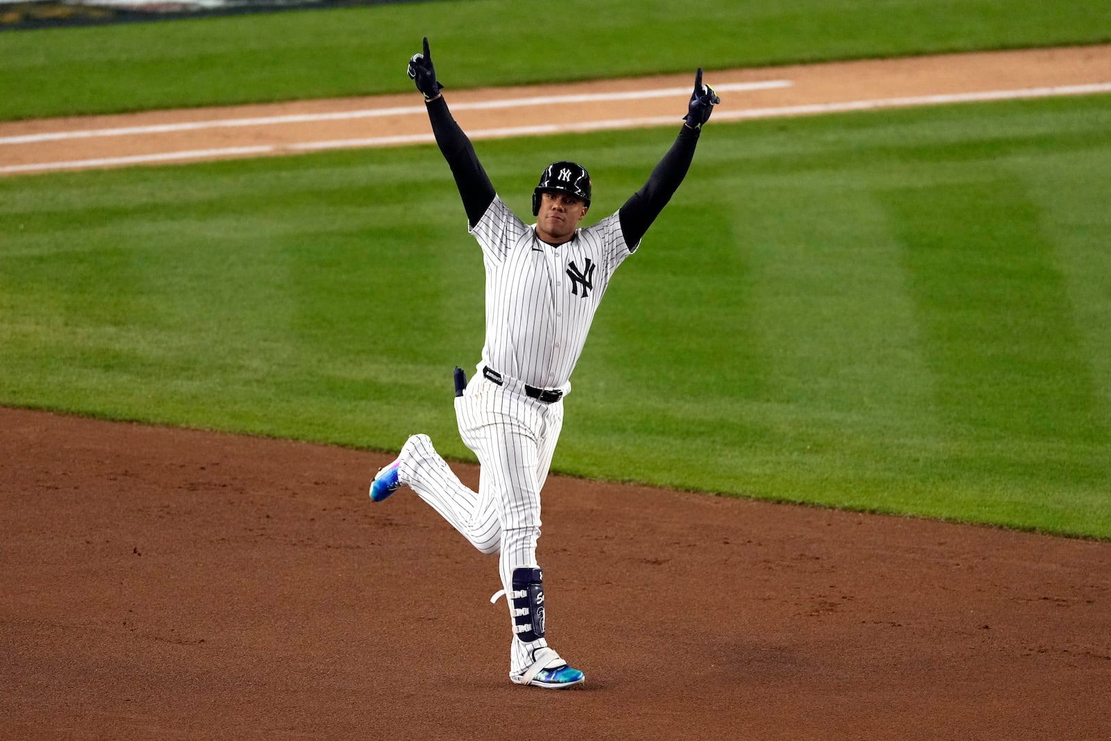 New York Yankees' Juan Soto celebrates after hitting a home run against the Cleveland Guardians during the third inning in Game 1 of the baseball AL Championship Series Monday, Oct. 14, 2024, in New York. (AP Photo/Seth Wenig)