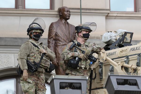 Armed National Guard troops guard the state Capitol near statue of Martin Luther King Jr. in downtown Atlanta on Sunday, Jan. 17, 2021. Armed militias had threated to protest the election of President-Elect Joe Biden ahead of Wednesday's inauguration. (Curtis Compton / Curtis.Compton@ajc.com)  