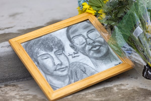 A drawing of Christian Angulo and Mason Schermerhorn rests at a vigil at Winder's Jug Tavern Park.