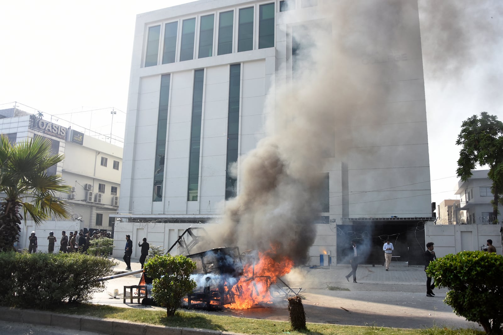 Smoke erupts from burning furniture and other materials set on fire by angry students protesting over an alleged on-campus rape in Punjab, in Rawalpindi, Pakistan, Thursday, Oct. 17, 2024. (AP Photo/W.K. Yousafzai)