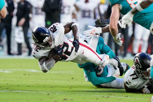 Atlanta Falcons running back Godwin Igwebuike (42) is brought down by Miami Dolphins cornerback Eli Apple (33) after a short gain in the first half of a preseason an NFL football game, Friday, Aug. 11, 2023, in Miami Gardens, Fla. (AP Photo/Wilfredo Lee)