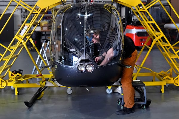 Avionics Technician John Beto installs components into the cockpit of an unmanned semi-autonomous helicopter being built in a hanger at Rotor Technologies , Monday, Nov. 11, 2024, in Nashua, N.H. (AP Photo/Charles Krupa)