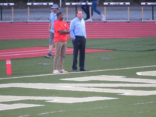 Auburn coach Gus Malzahn (right) and Tigers receivers coach Cody Burns attend Denmark's football game at Blessed Trinity in Roswell on Friday, Oct. 11, 2019. (Adam Krohn/special)