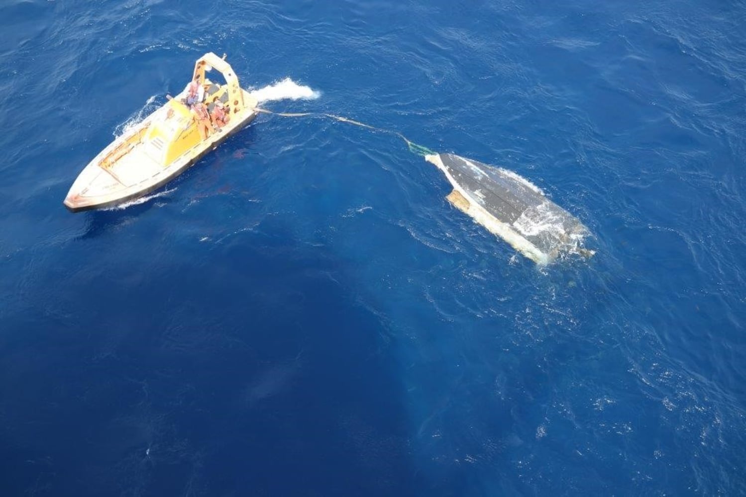 Photos of missing teens' boat being pulled from water