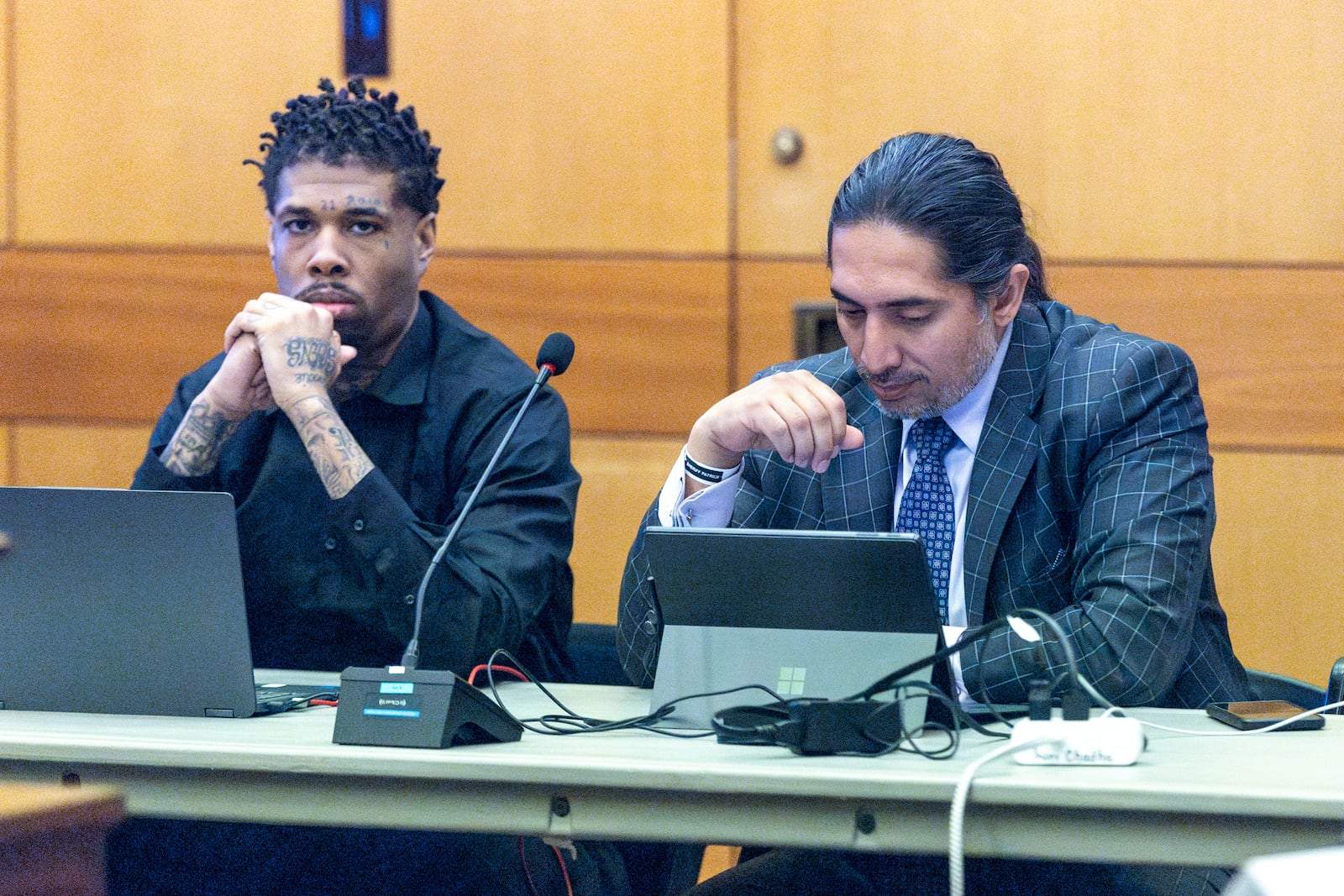 Cordarius Dorsey (left) sits alongside attorney Suri Chadha Jimenez during jury selection in the “Young Slime Life” gang case. The state is dismissing Dorsey's gang charges in light of his most recent murder conviction. (Steve Schaefer/steve.schaefer@ajc.com)