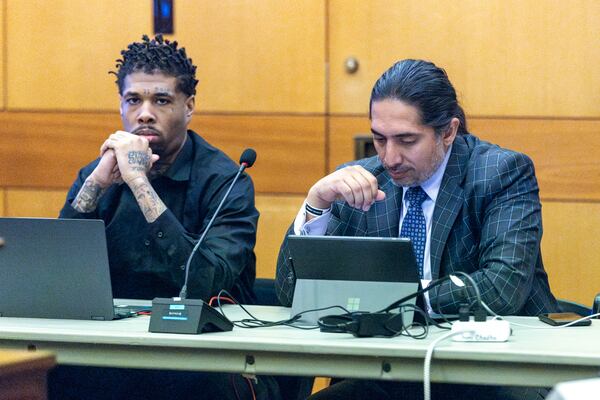 Cordarius Dorsey (left) sits alongside attorney Suri Chadha Jimenez during jury selection in the “Young Slime Life” gang case. The state is dismissing Dorsey's gang charges in light of his most recent murder conviction. (Steve Schaefer/steve.schaefer@ajc.com)