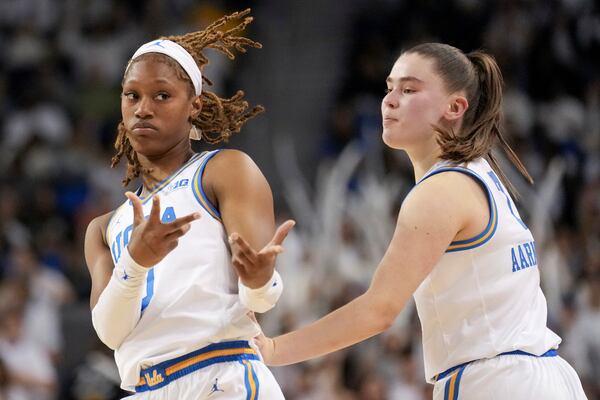 UCLA forward Janiah Barker, left, reacts with teammate guard Elina Aarnisalo, right, after making a basket during the second half of an NCAA college basketball game against South Carolina, Sunday, Nov. 24, 2024, in Los Angeles. (AP Photo/Eric Thayer)