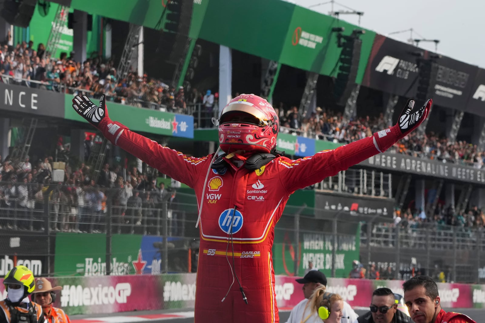 Ferrari driver Carlos Sainz of Spain celebrates after winning the Formula One Mexico Grand Prix auto race at the Hermanos Rodriguez racetrack in Mexico City, Sunday, Oct. 27, 2024. (AP Photo/Fernando Llano)