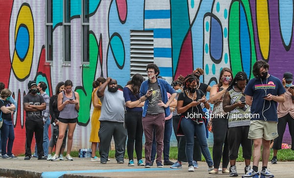 Voters wait in line at Cross Keys High School on Tuesday, June 9, 2020. JOHN SPINK / AJC