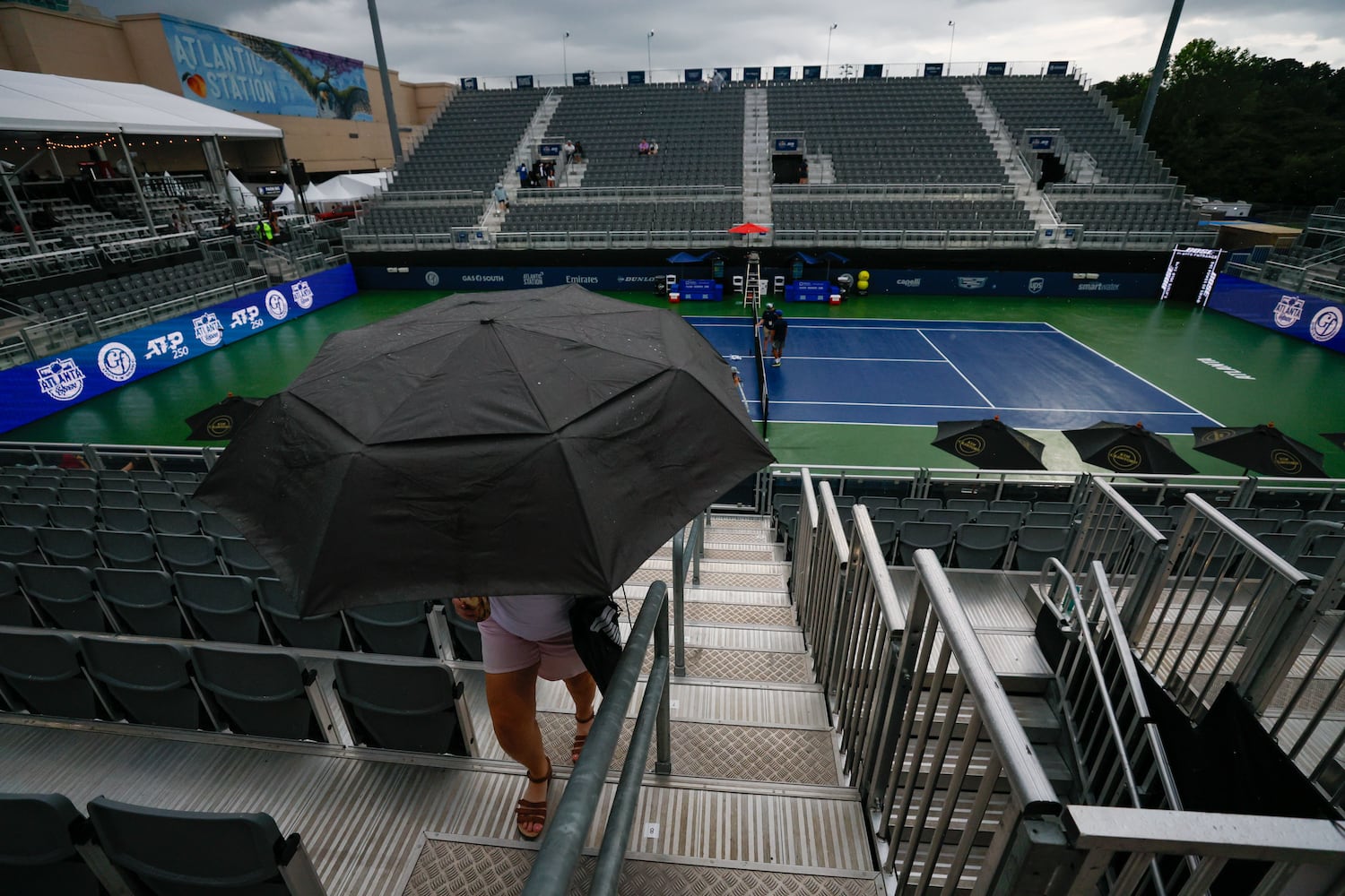 Heather Shaver from Tucker is seen carrying an umbrella as the rain began to fall before the Atlanta Open in Atlantic Station exhibition match on Sunday, July 21, 2024.
(Miguel Martinez / AJC)