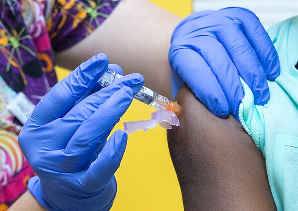 In this file photo, a flu shot is administered to a child at Conyers Pediatrics in Conyers.
 (Alyssa Pointer/Atlanta Journal-Constitution)